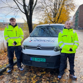 To menn staar ute foran en varebil